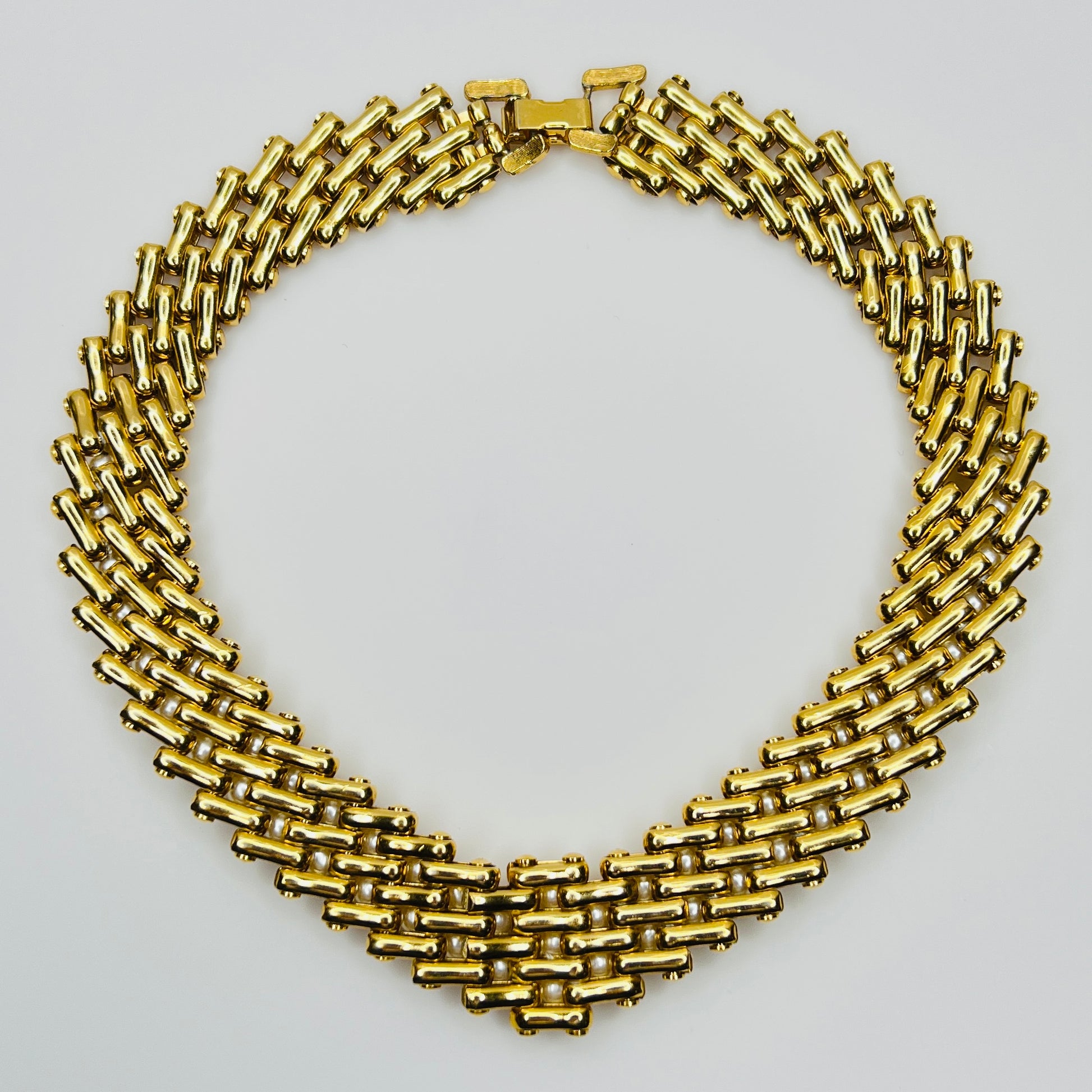 V-shaped gold-tone choker necklace with faux pearls in stacked link design
