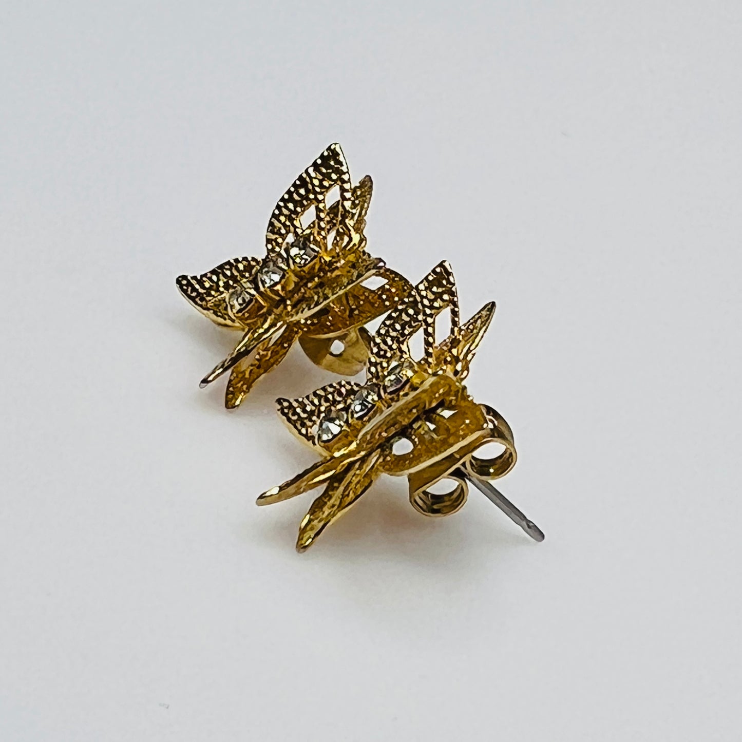 Vintage gold filigree butterfly stud earrings with rhinestone accents