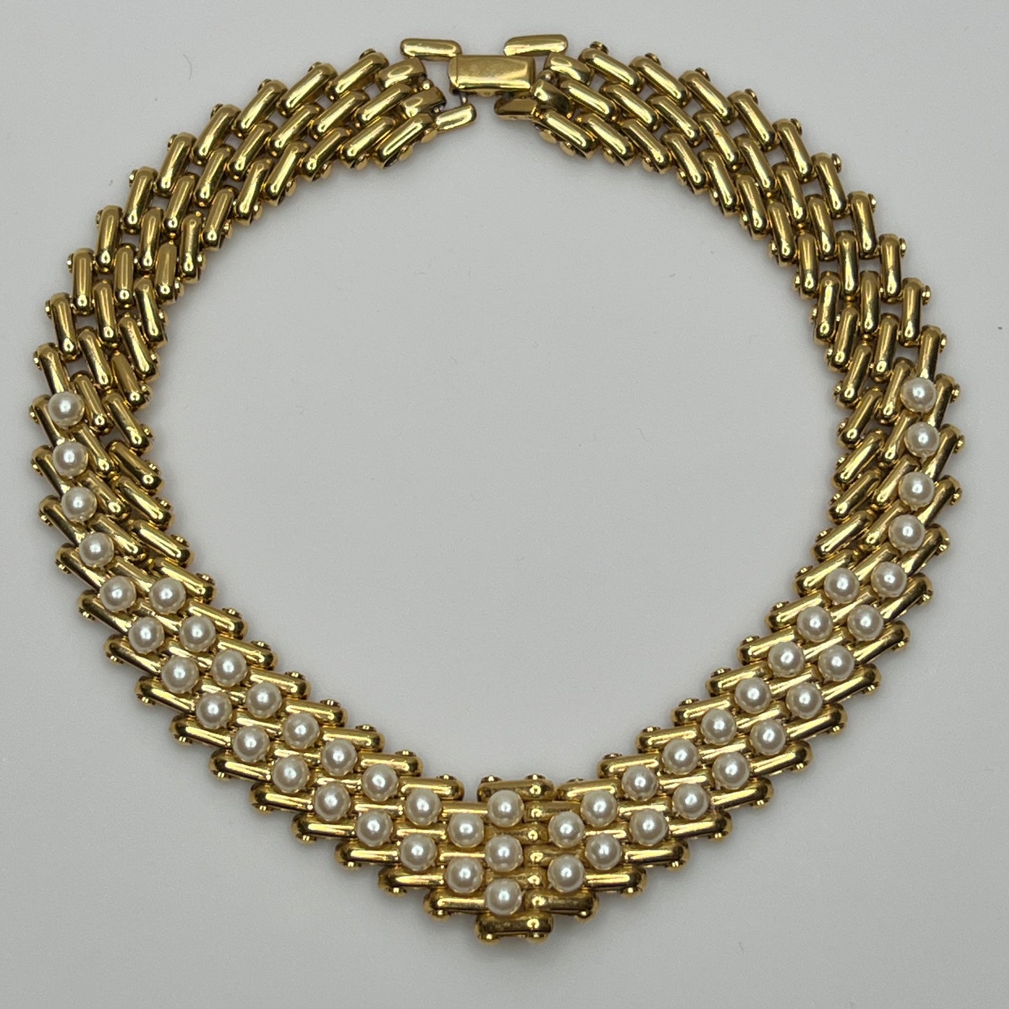 V-shaped gold-tone choker necklace with faux pearls in stacked link design