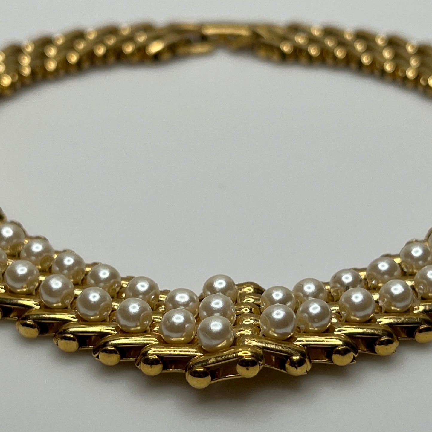 V-shaped gold-tone choker necklace with faux pearls in stacked link design