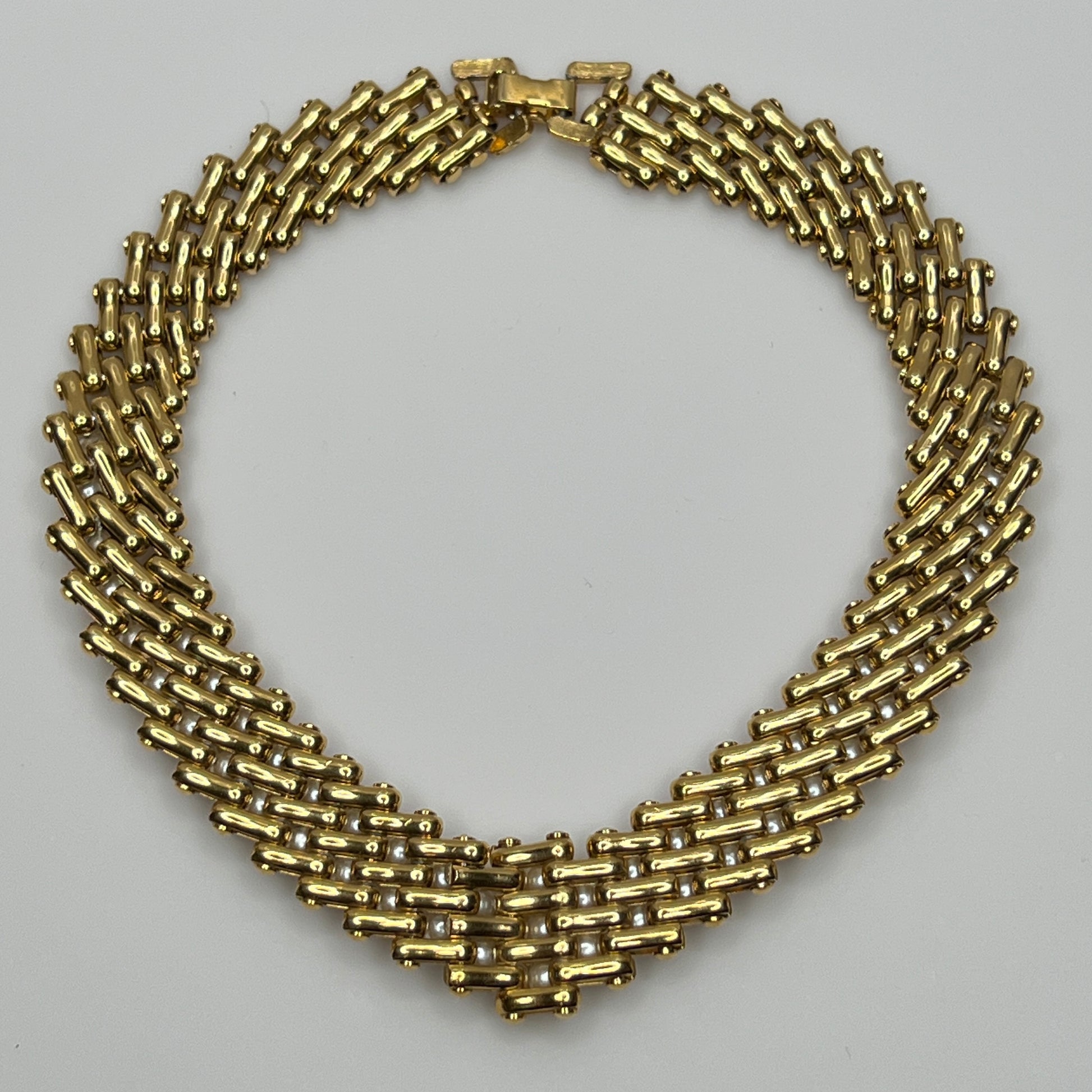 V-shaped gold-tone choker necklace with faux pearls in stacked link design