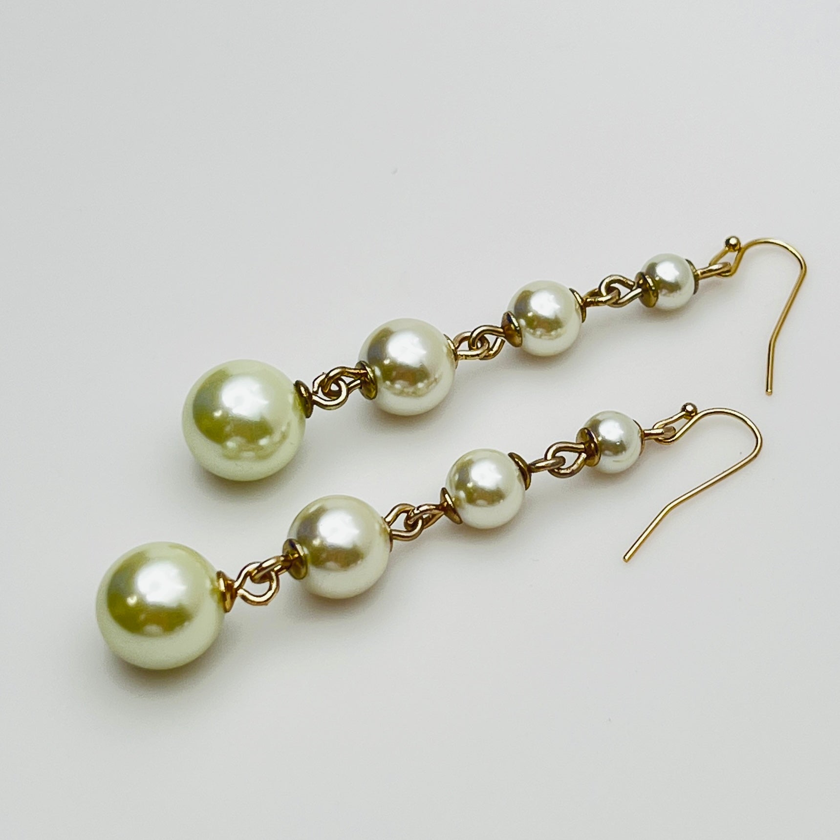 Vintage Lulu Frost long dangle earrings with graduated faux pearls on gold-tone wires