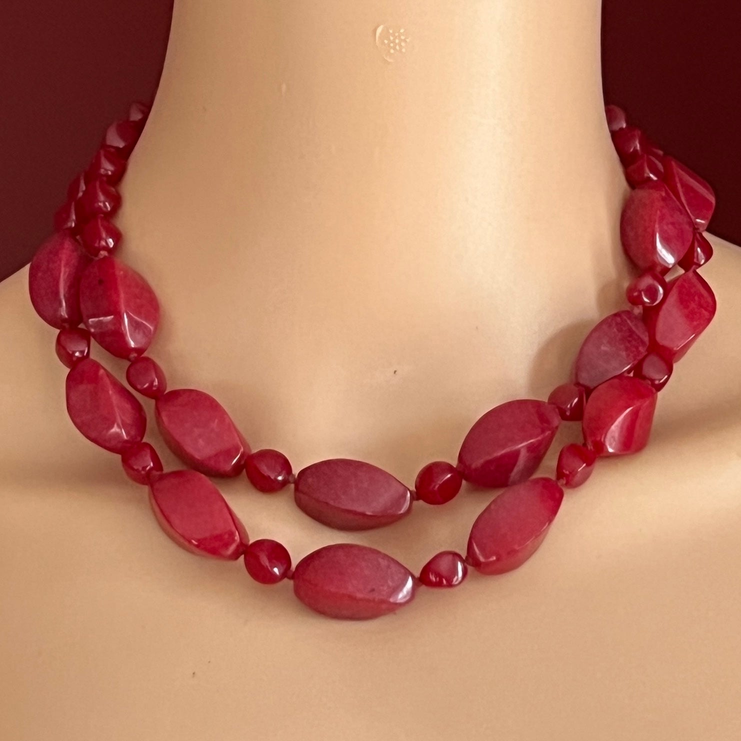 Red vintage necklace shown on mannequin with layered bold cherry beads