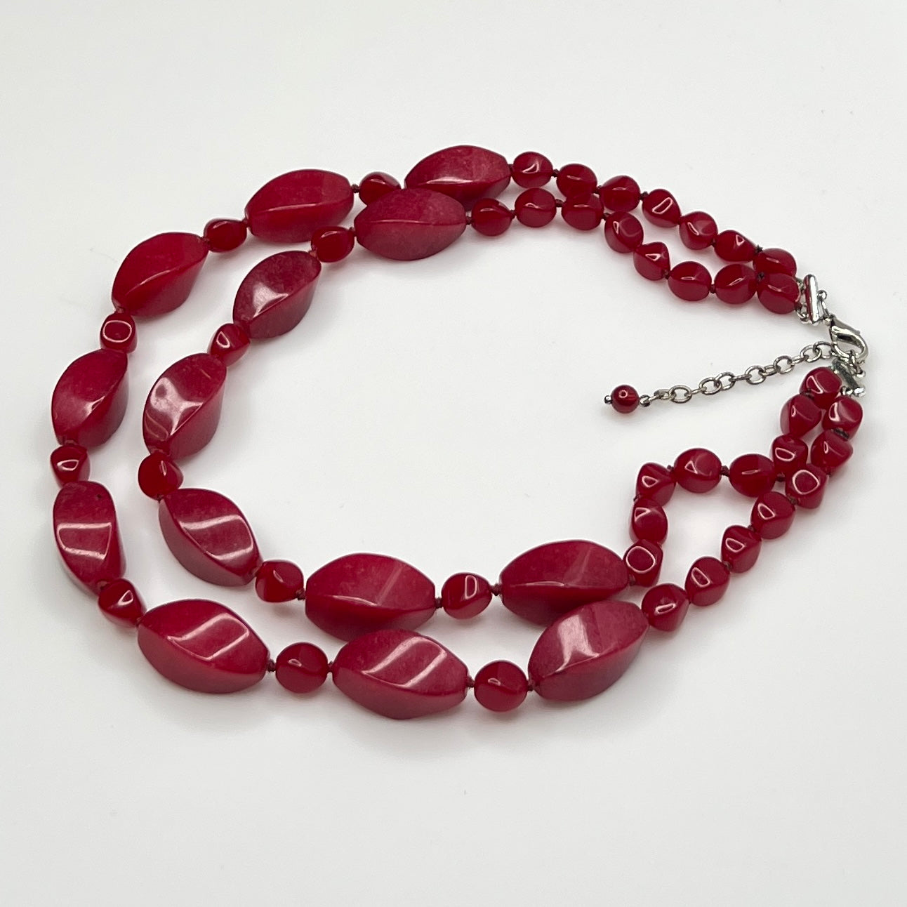 Double strand red bead necklace with large glass ovals and smaller lucite rounds with silver-tone clasp