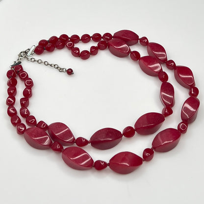 Double strand red bead necklace with large glass ovals and smaller lucite rounds with silver-tone clasp
