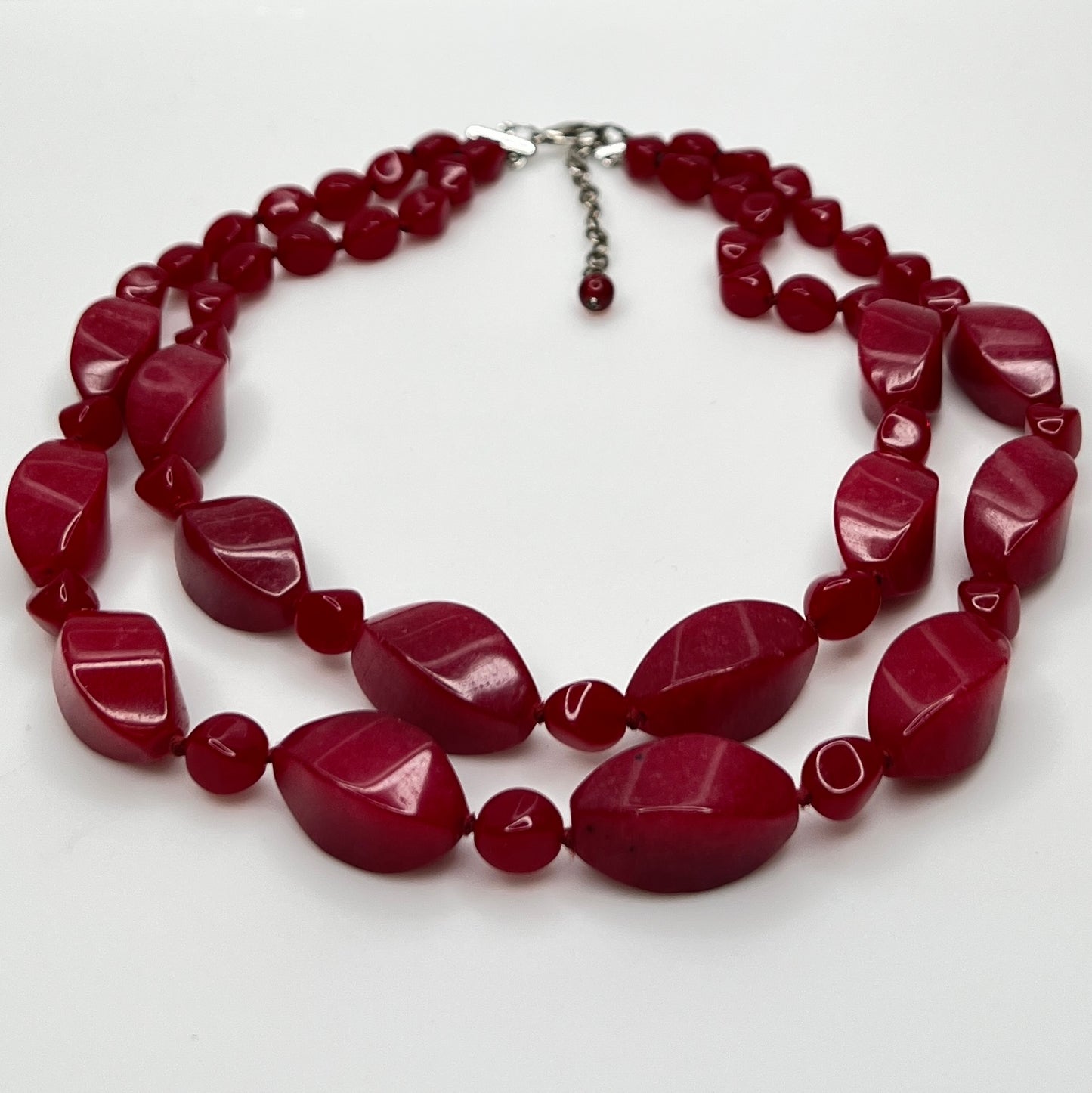 Double strand red bead necklace with large glass ovals and smaller lucite rounds with silver-tone clasp