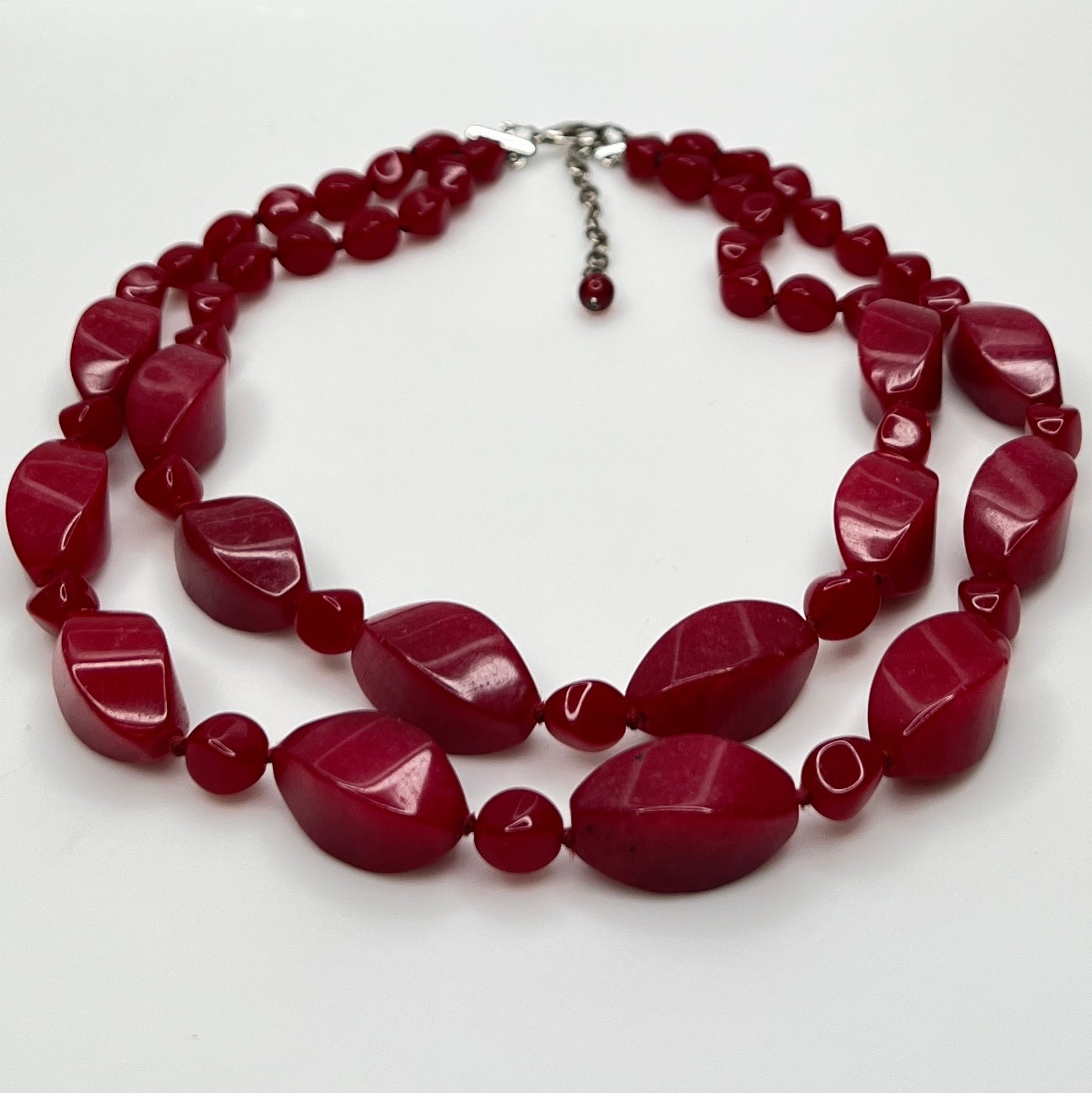 Double strand red bead necklace with large glass ovals and smaller lucite rounds with silver-tone clasp