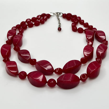 Double strand red bead necklace with large glass ovals and smaller lucite rounds with silver-tone clasp