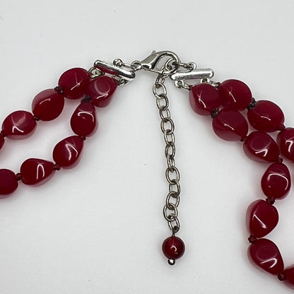 Double strand red bead necklace with large glass ovals and smaller lucite rounds with silver-tone clasp