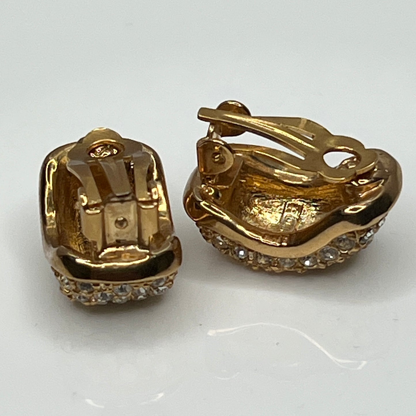 Gold rhinestone clip-on earrings signed Roman with pave setting