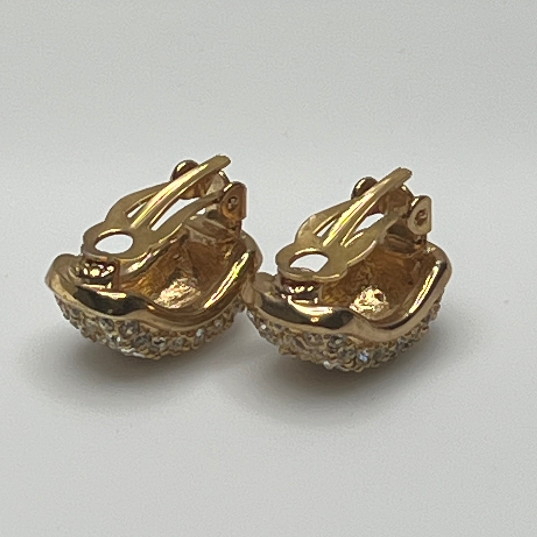Gold rhinestone clip-on earrings signed Roman with pave setting