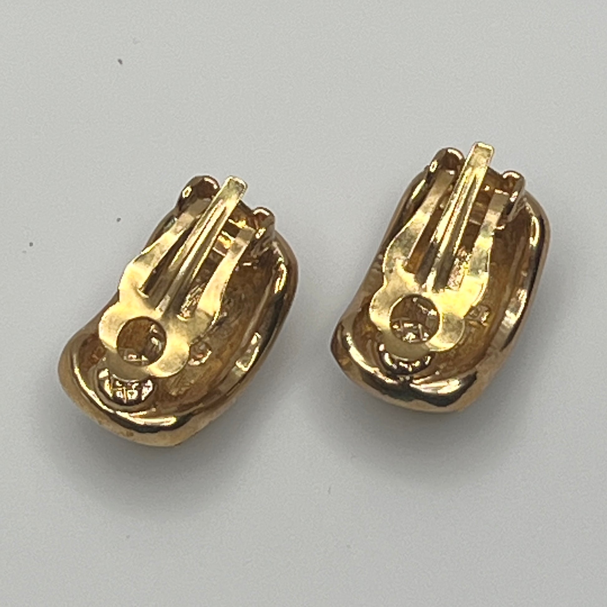 Gold rhinestone clip-on earrings signed Roman with pave setting