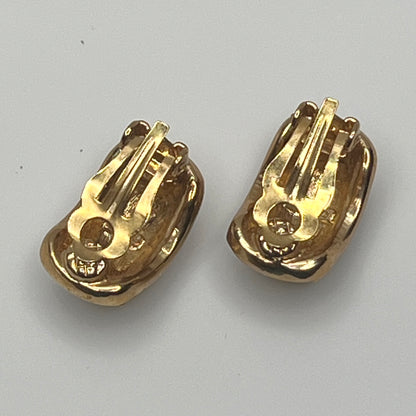 Gold rhinestone clip-on earrings signed Roman with pave setting