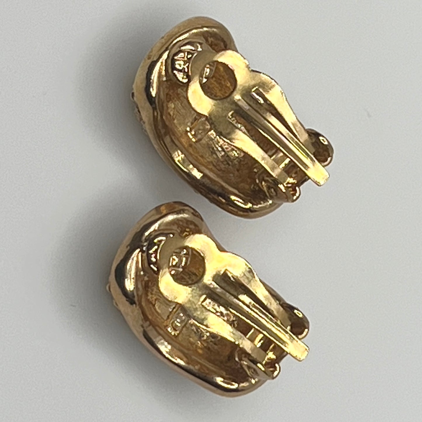 Gold rhinestone clip-on earrings signed Roman with pave setting