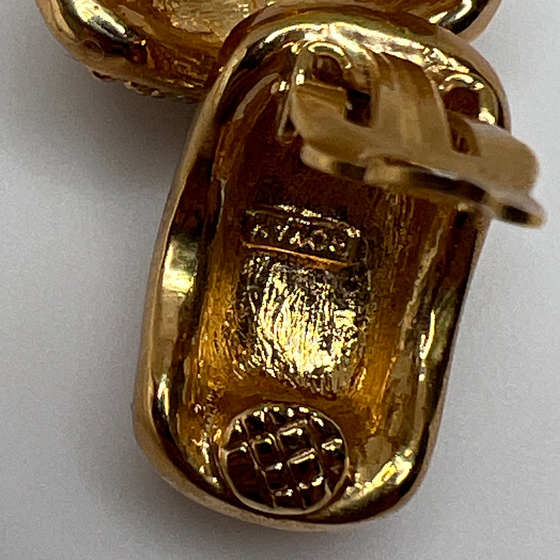 Gold rhinestone clip-on earrings signed Roman with pave setting