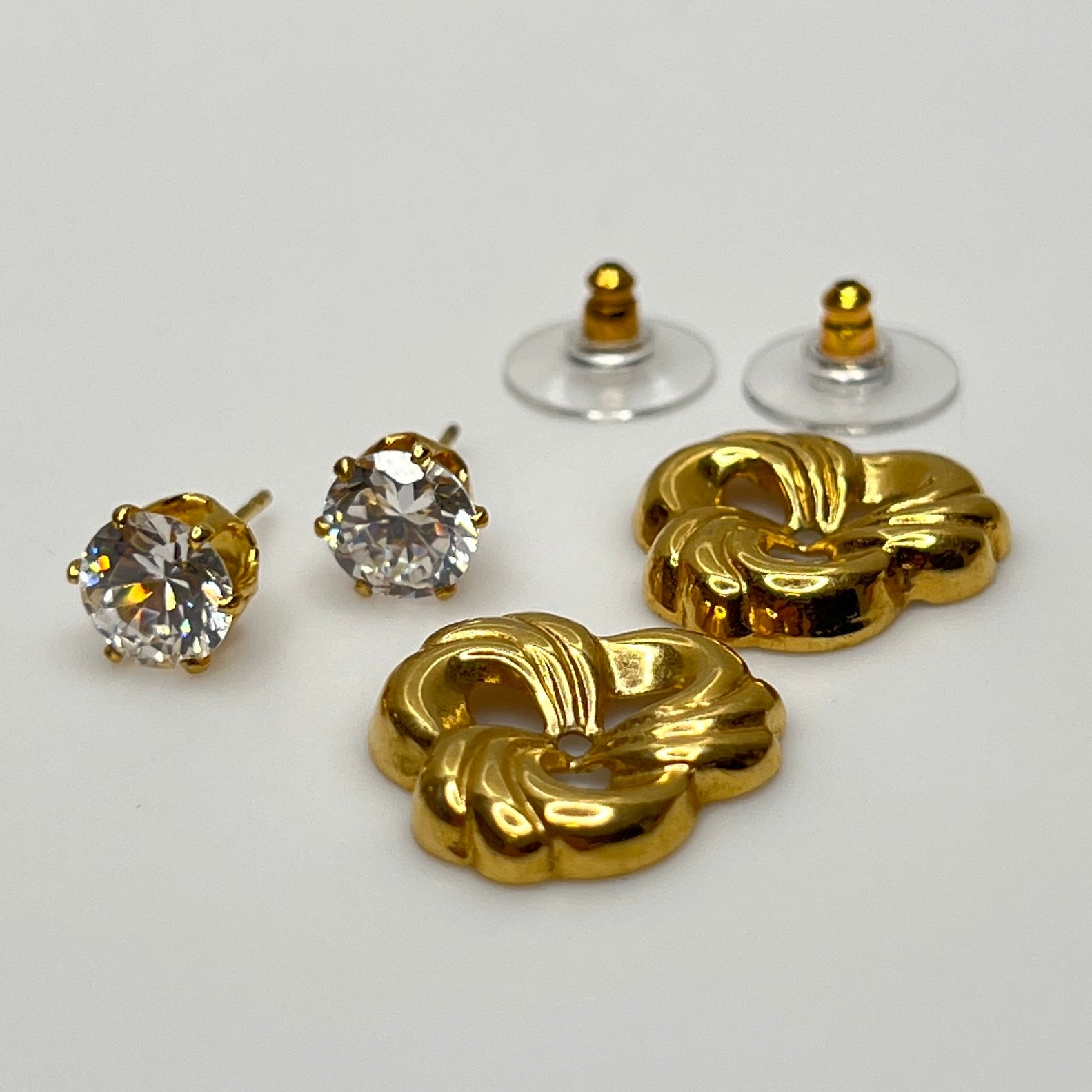 Crystal stud earrings with removable gold-tone swirl jackets