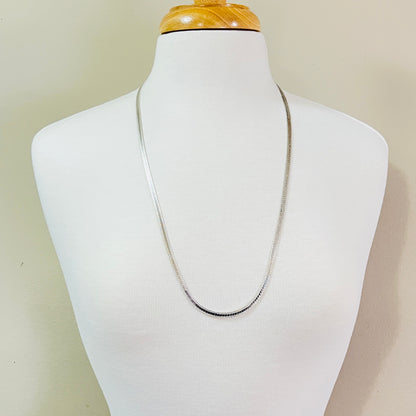 Vintage sterling silver snake chain necklace displayed on jewelry bust