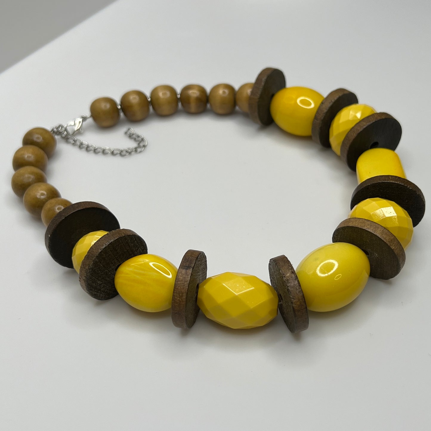 Detail of round wood neck beads and contrasting textures