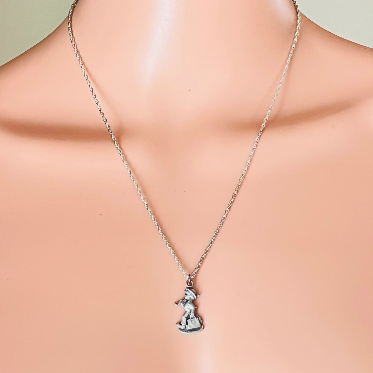 Sterling silver Hummel girl pendant necklace on mannequin bust