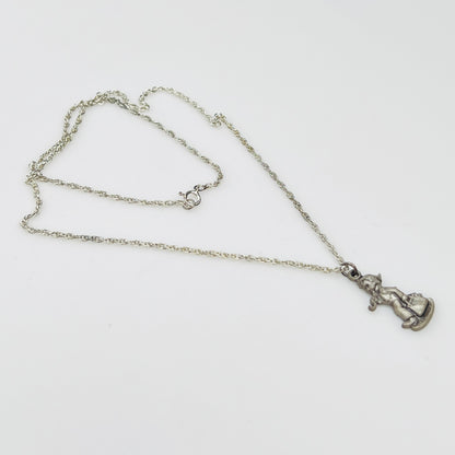 Side view Flat lay of silver Hummel pendant necklace with twist chain