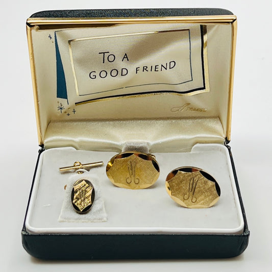 Gold cufflinks and tie clip set in a decorative box with 'To a Good Friend' message.