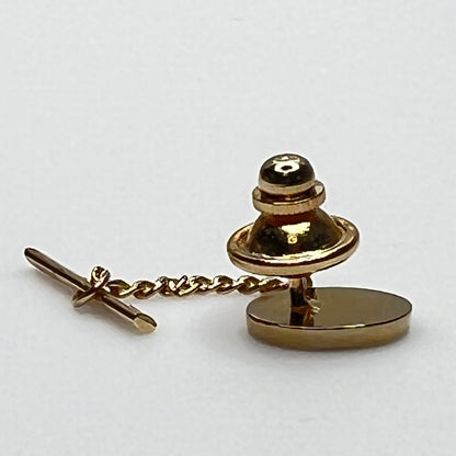Close-up of monogrammed “M” cufflinks and matching gold-tone tie tack