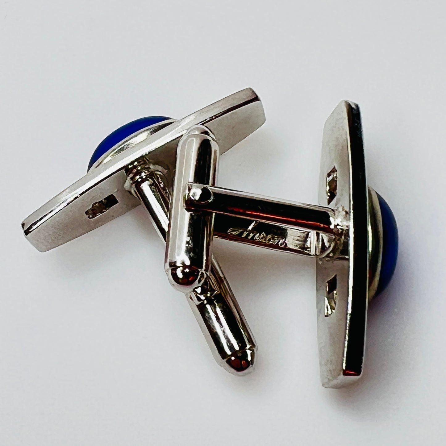 Silver-tone cufflinks with textured finish and vivid blue lucite cabochons, signed Anson