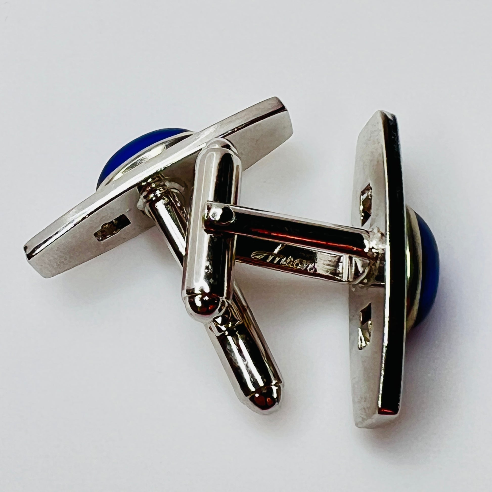 Silver-tone cufflinks with textured finish and vivid blue lucite cabochons, signed Anson