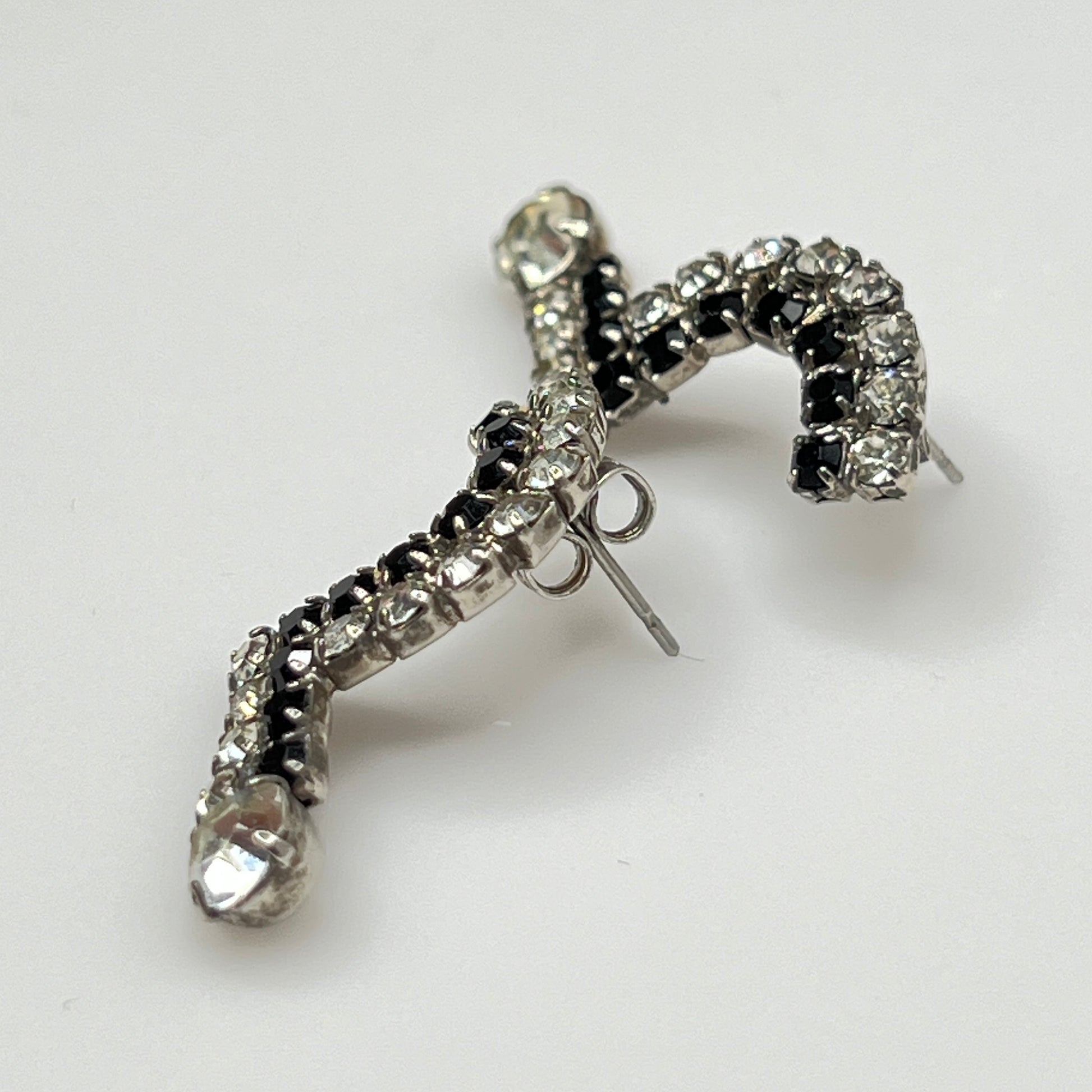 Art Deco-style vintage rhinestone earrings in black and clear zigzag shape