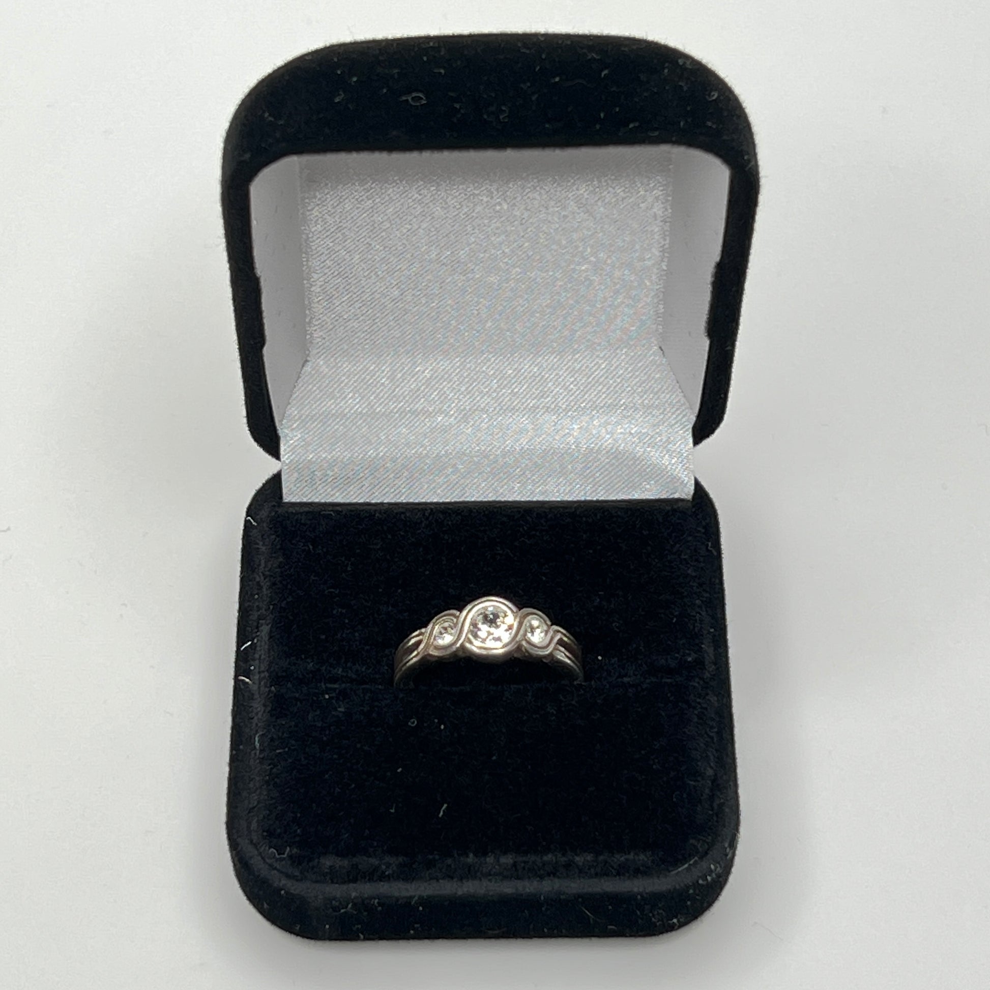 Detailed view of crystal trio wave setting in silver