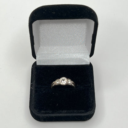 Detailed view of crystal trio wave setting in silver