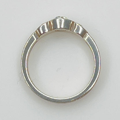 Detailed view of crystal trio wave setting in silver