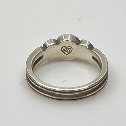 Detailed view of crystal trio wave setting in silver