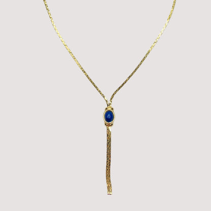 Full view of necklace with lariat drop and blue stone on white background
