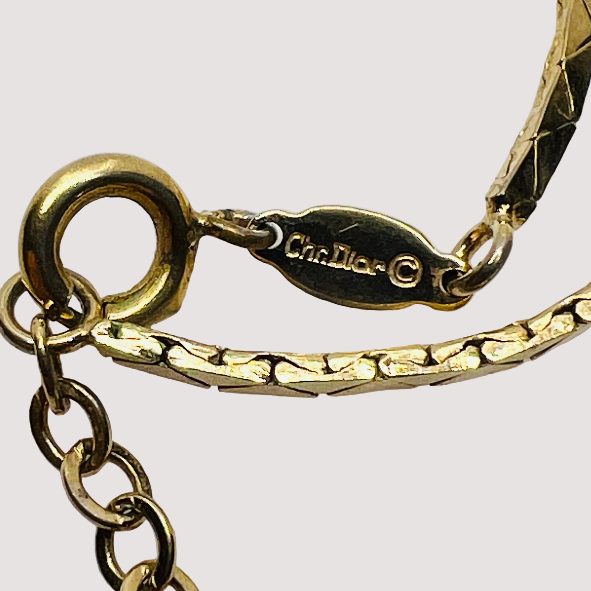 Signature clasp stamped “Chr. Dior ©” in goldtone finish
