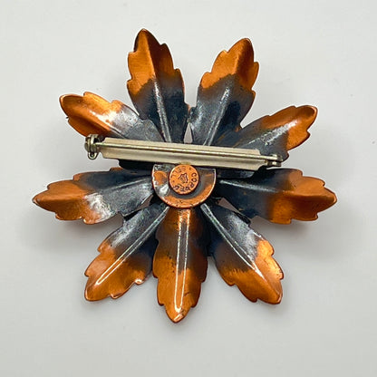Reverse of copper brooch showing Copper Bell stamp and bell logo