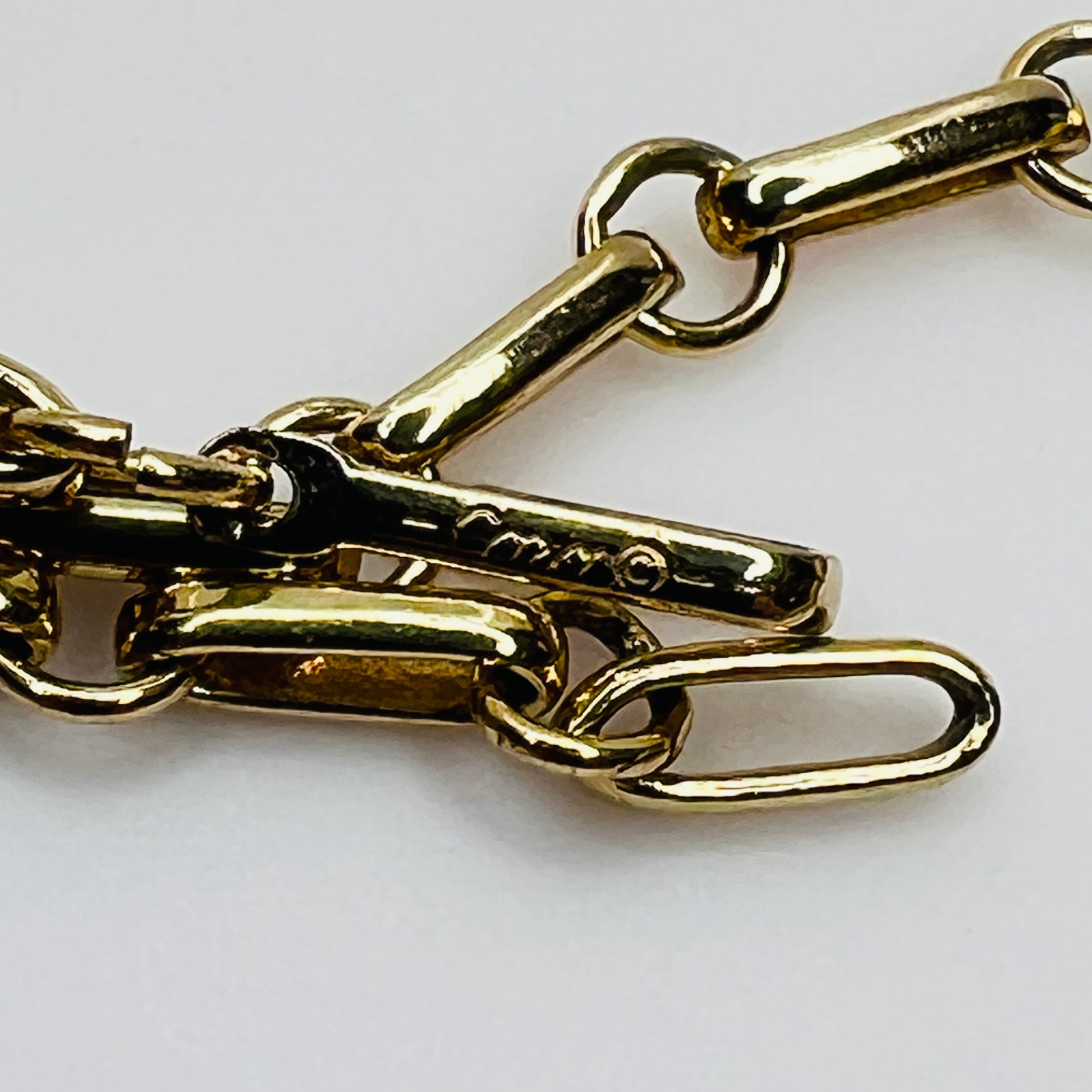 Close-up of signed Coro gold-tone hook clasp and extender chain