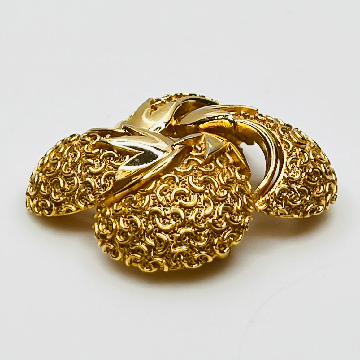 Side angle showing dimensional texture and sculpted swirl detailing