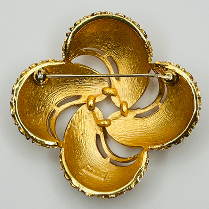 Back view Crown Trifari gold swirl brooch with clover-style textured domes