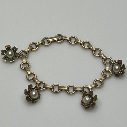 Vintage floral charm bracelet with textured links and pearl accents