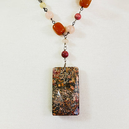 Close-up of rectangular granite pendant with mixed gemstone beads