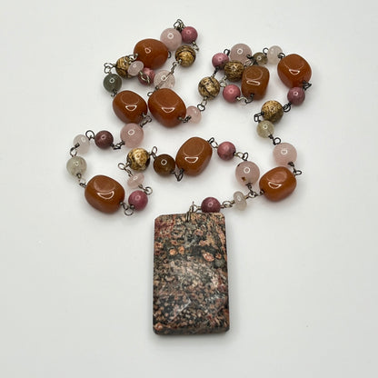 Close-up of rectangular granite pendant with mixed gemstone beads