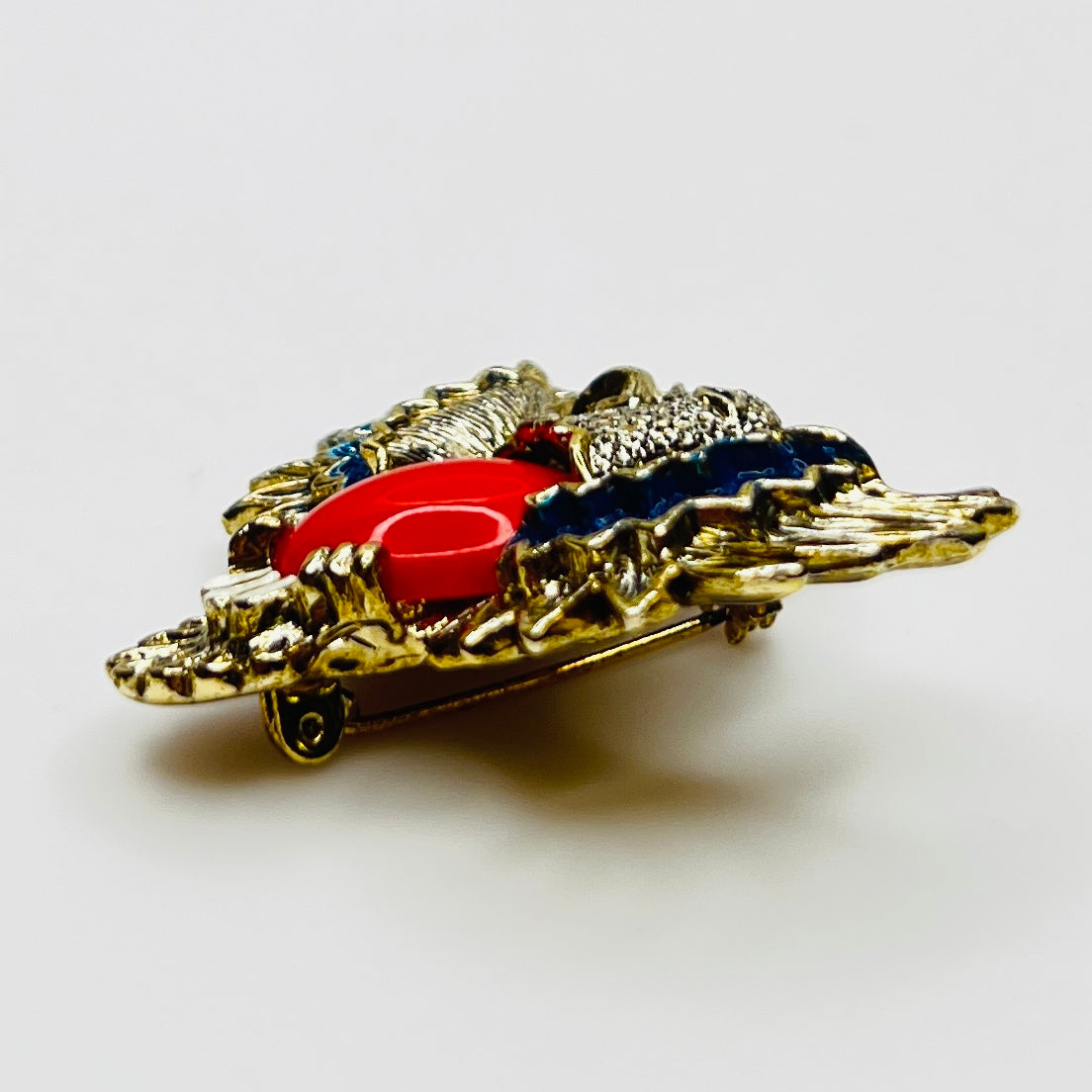 Side view of enamel wing detail on vintage eagle pin