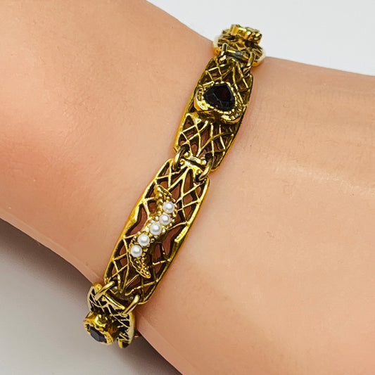 Vintage Goldette NY bracelet with filigree panels and pearl/jewel accents shown on wrist