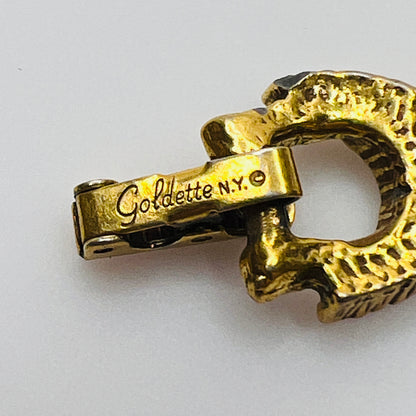 Filigree bracelet with varied gemstone details laid flat, fold-over clasp visible