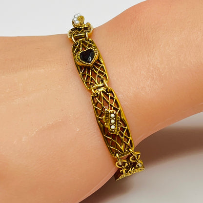 Vintage Goldette NY bracelet with filigree panels and pearl/jewel accents shown on wrist