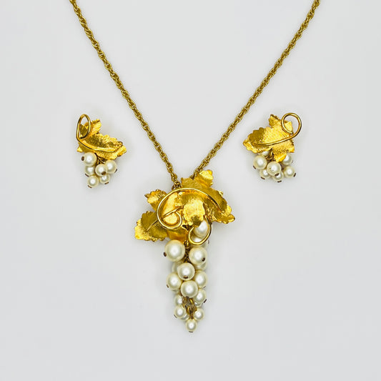 Close-up of 1950s faux pearl grape cluster clip-on earrings and convertible pendant