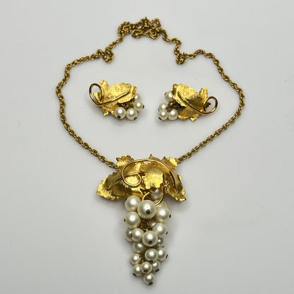 Close-up of 1950s faux pearl grape cluster clip-on earrings and convertible pendant