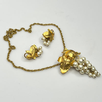 Close-up of 1950s faux pearl grape cluster clip-on earrings and convertible pendant