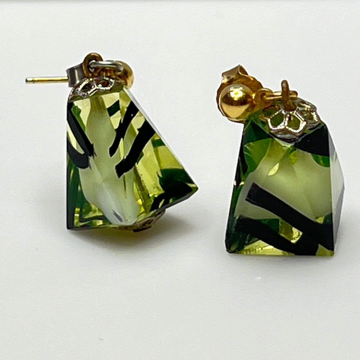 Green glass pyramid earrings with black swirl pattern, vintage 1980s pierced dangle design